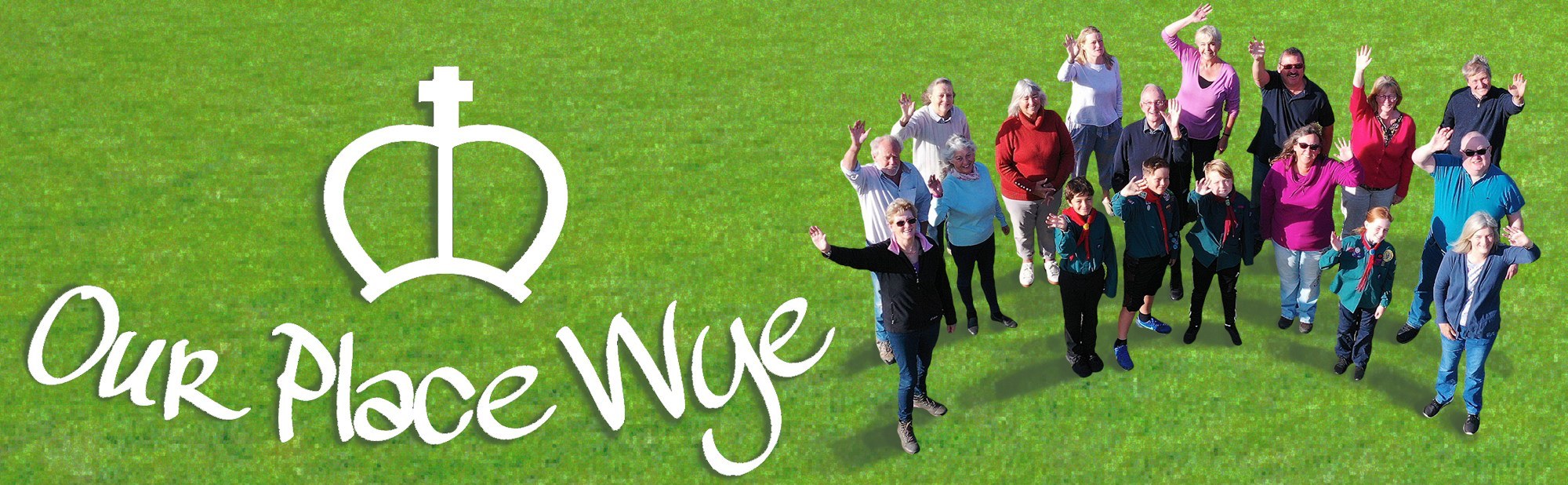 Group of Wye, Ashford residents on grass with Our Place Wye logo